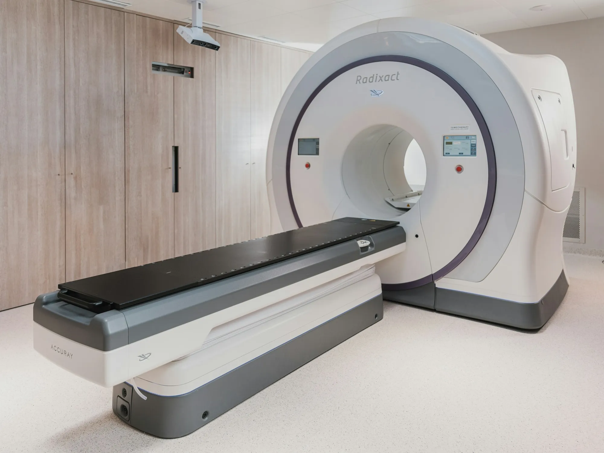 A modern scanner and patient table in a hospital imaging room