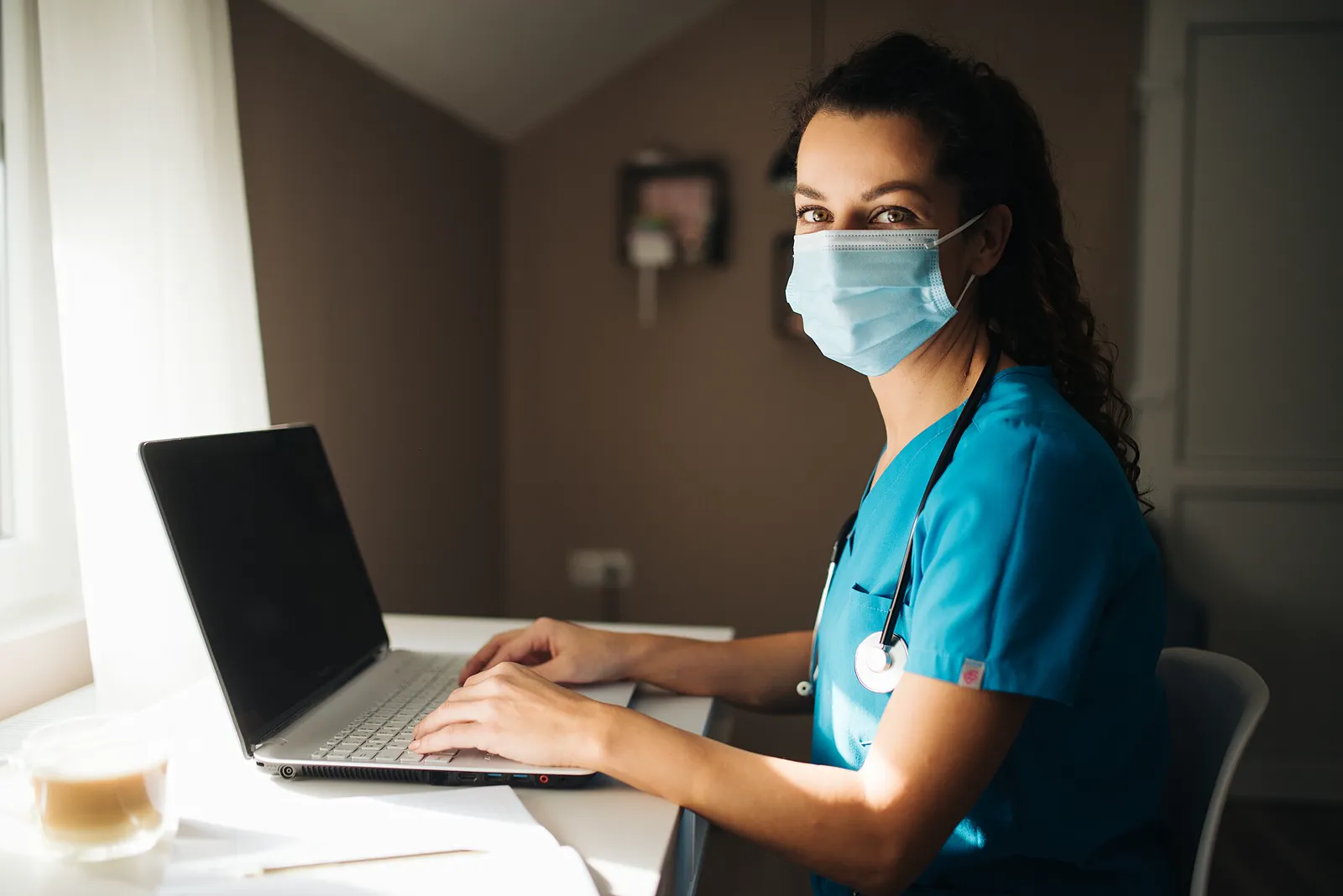 A doctor at a laptop, ready to begin a scheduled telemedicine consultation